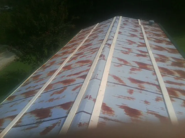 Rusted metal roof panels with new wood purlins before replacement — Storm Damage Roof Repair in La Jose by Roofing Brothers