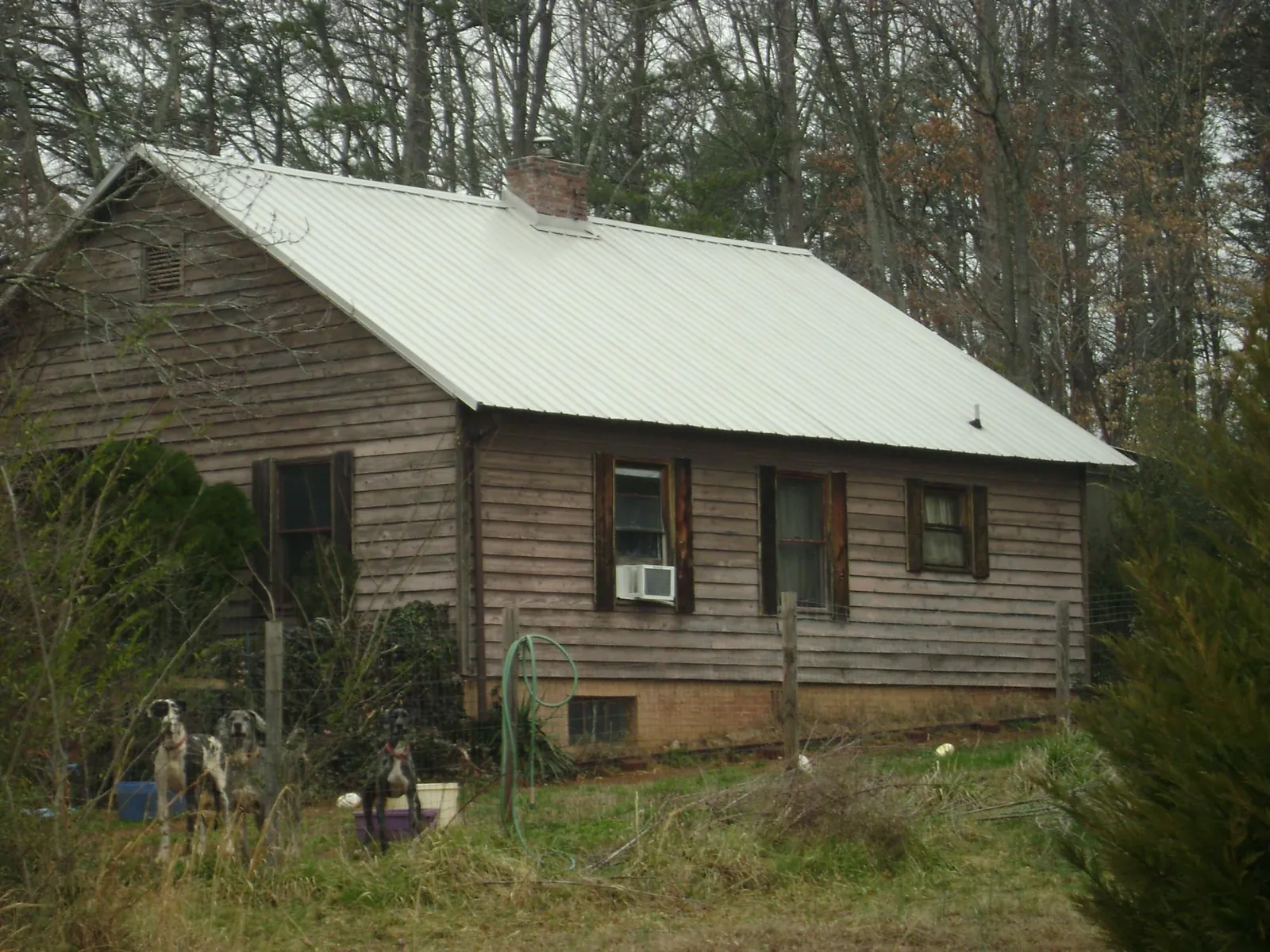 White metal roof on an old wood sided farmhouse, from a Metal Roof Installation job in La Jose